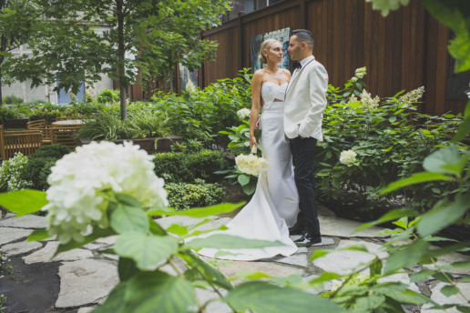 Couple standing together looking into each other's eyes in the garden of the Ritz-Carlton Montreal