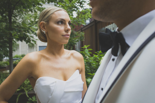 Close up of a woman with a man in the foreground in the garden of the Ritz-Carlton Montreal on their wedding day