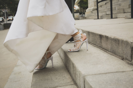 Close up of a bride's shoes as she walks down the steps of the montreal museum of fine arts
