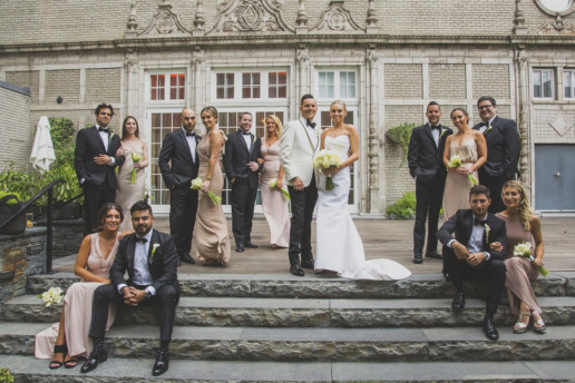 large fifteen person bridal party in a vanity fair style portrait in the garden of the Riyz-Carlton hotel