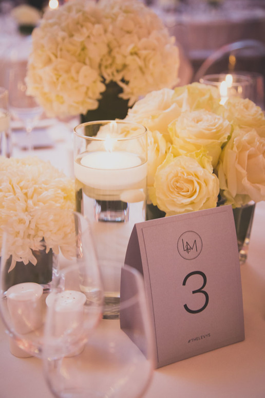 Table place cards, candles and white flowers in the Oval room