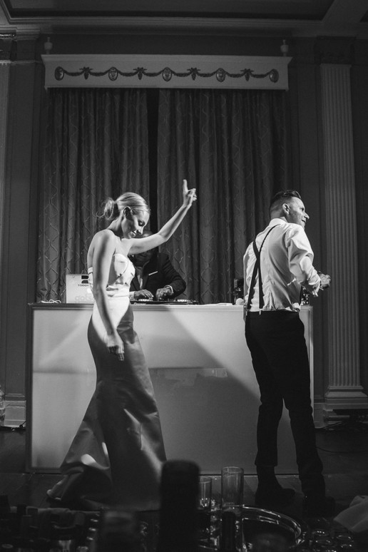 Bride and Groom dance on stage in the Oval Room at the Ritz-Carlton in front of DJ Toddy Flores