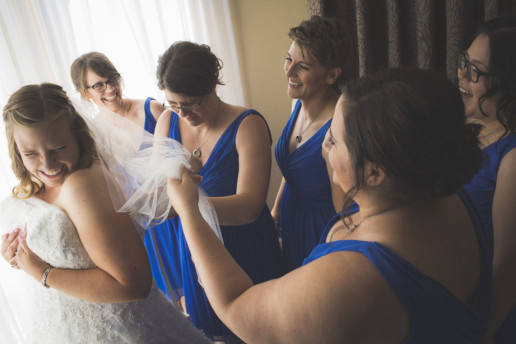 Bridesmaids get the bride in her wedding dress in the suite at the Rimrock Resort and hotel in Banff