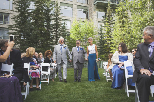 Parents walk the groom down the aisle in an outdoor Jewish wedding ceremony at the Rimrock resort and hotel