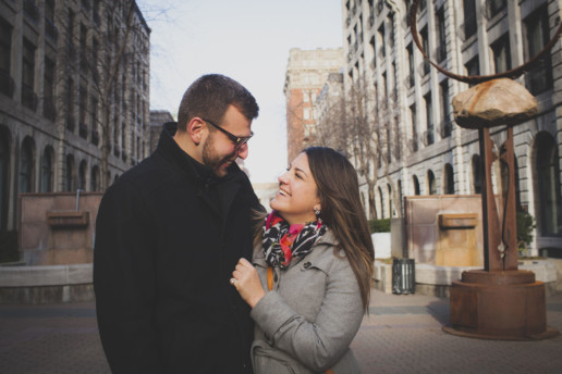 a couple laugh together just after getting engaged in old montreal