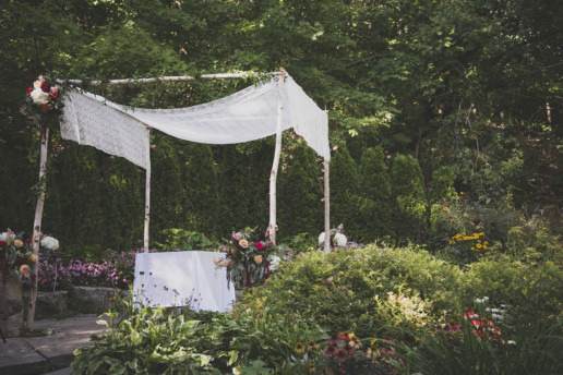 The trends are for lots of greenery and more outdoor ceremonies, like this Jewish wedding in a garden with a white lace chuppah at Fantasy Farms in Toronto