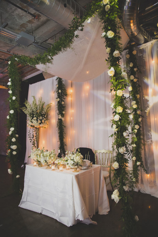 A lot of greenery and white flowers with fairy lights set the mood for the neutral palette for the decor at Gare Viger in Montreal