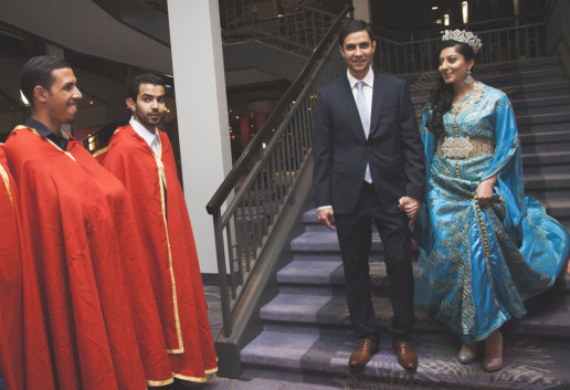 Arabic bride and groom walk down the stairs in a blue wedding dress in Montreal