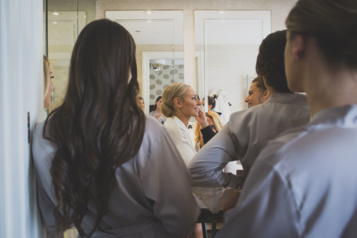 bridesmaids look on while the bride gets her make up applied by make up artist morgan leigh chinks in their suite at the Ritz-Carlton Montreal