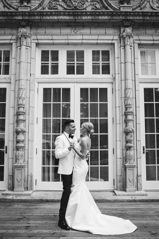 A couple dances in front of the french doors that lead from the garden of the Ritz-Carlton to the Oval room