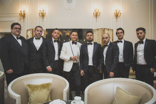 Groom and groomsmen in front of the Dom Perignon bar in the palm court of the Ritz-Carlton Montreal