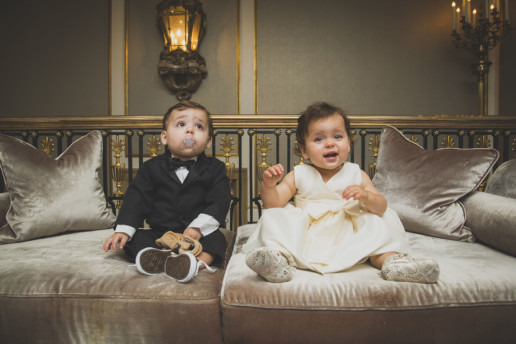 twin babies in a tuxedo and white satin flower girl dress at the Ritz Carlton-Montreal