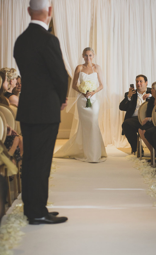 Bride walks down the aisle to her waiting father in the Gold room at the Ritz-Carlton Hotel in Montreal