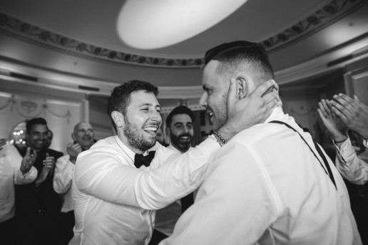 a groomsmen dances with the groom during the hora in the Oval room in Montreal