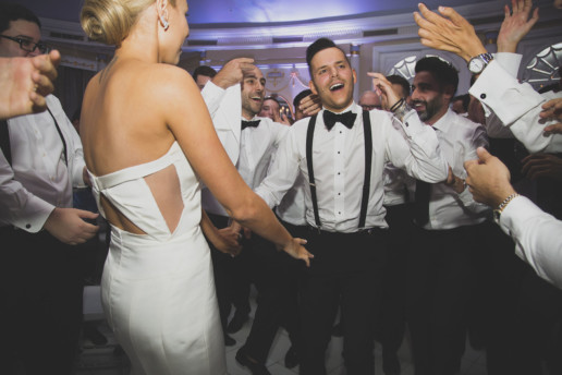 Groom dances with his bride and groomsmen on the dance floor of the Oval Room in Montreal