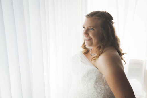 Woman in front of window on her wedding day