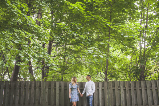 a man and a woman hold hands in their backyard in montreal